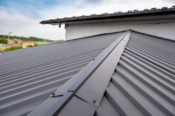 Gutter system for a metal roof. Holder gutter drainage system on the roof. Roofing contractor in Hagerstown, MD.