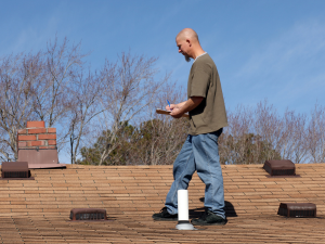 Roofer in Saint James making a detailed roof inspection report