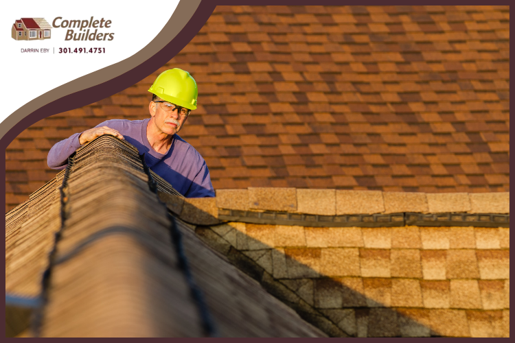 Expert roofer in Saint James inspecting roof shingles for winter preparation