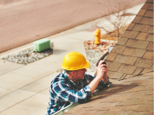 Professional Hagerstown roofing contractor inspecting a roof for storm preparation and repairs.